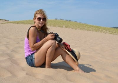 Alice Ford shooting photos on a sandy beach
