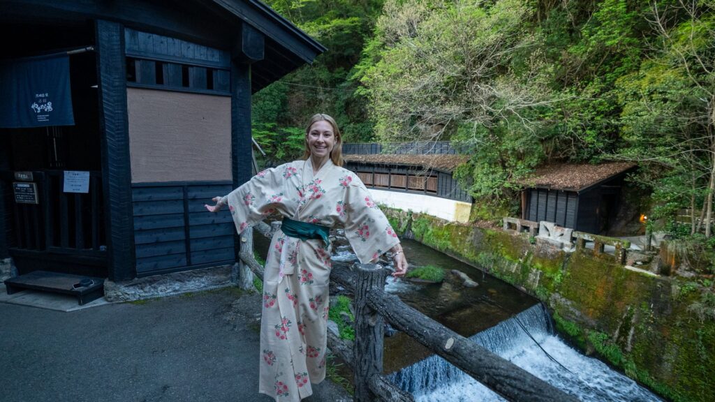 Alice Ford stands in a traditional kimono in front of her ryokan accommodations in Kyushu during an 8-day solo traveling trip across Japan