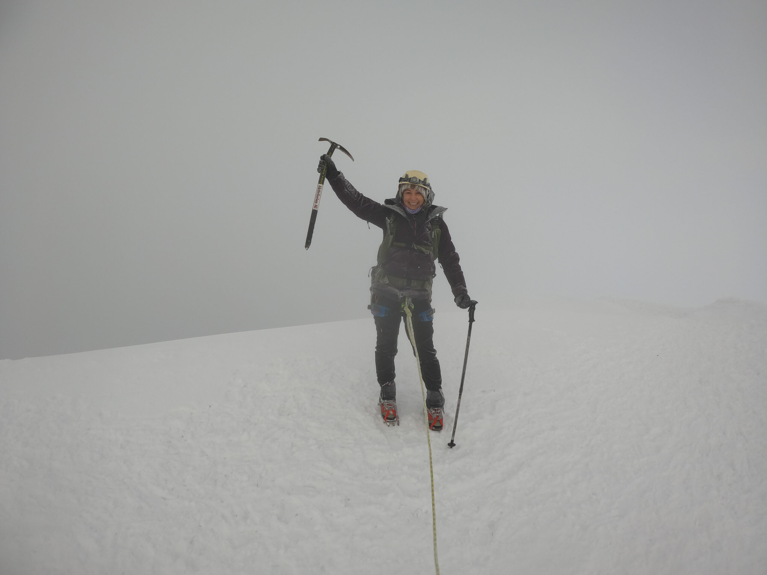 Woman with ice axe at the summit of Cotopaxi Volcano In Ecuador 