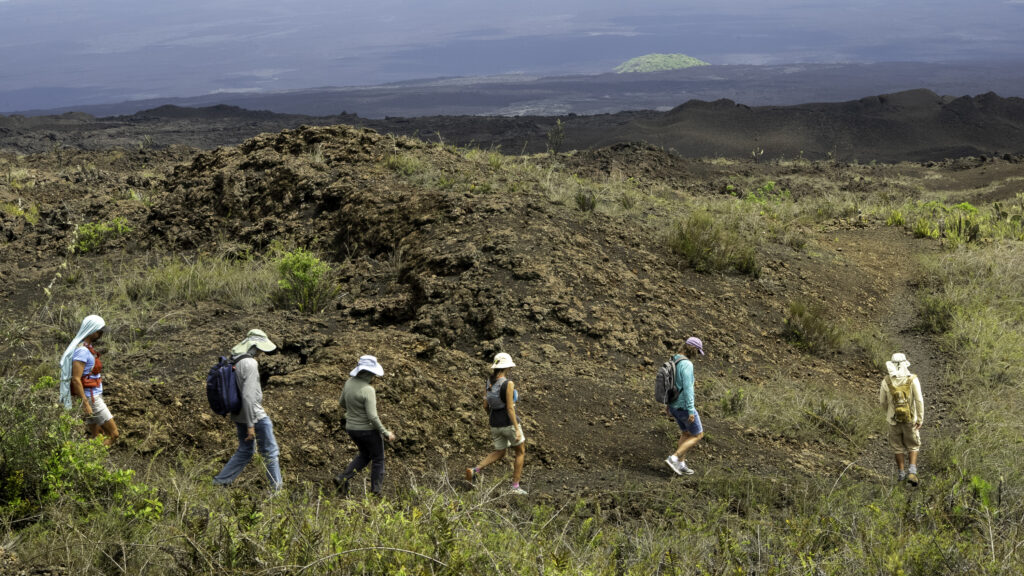 People hiking on a volcanic landscape
