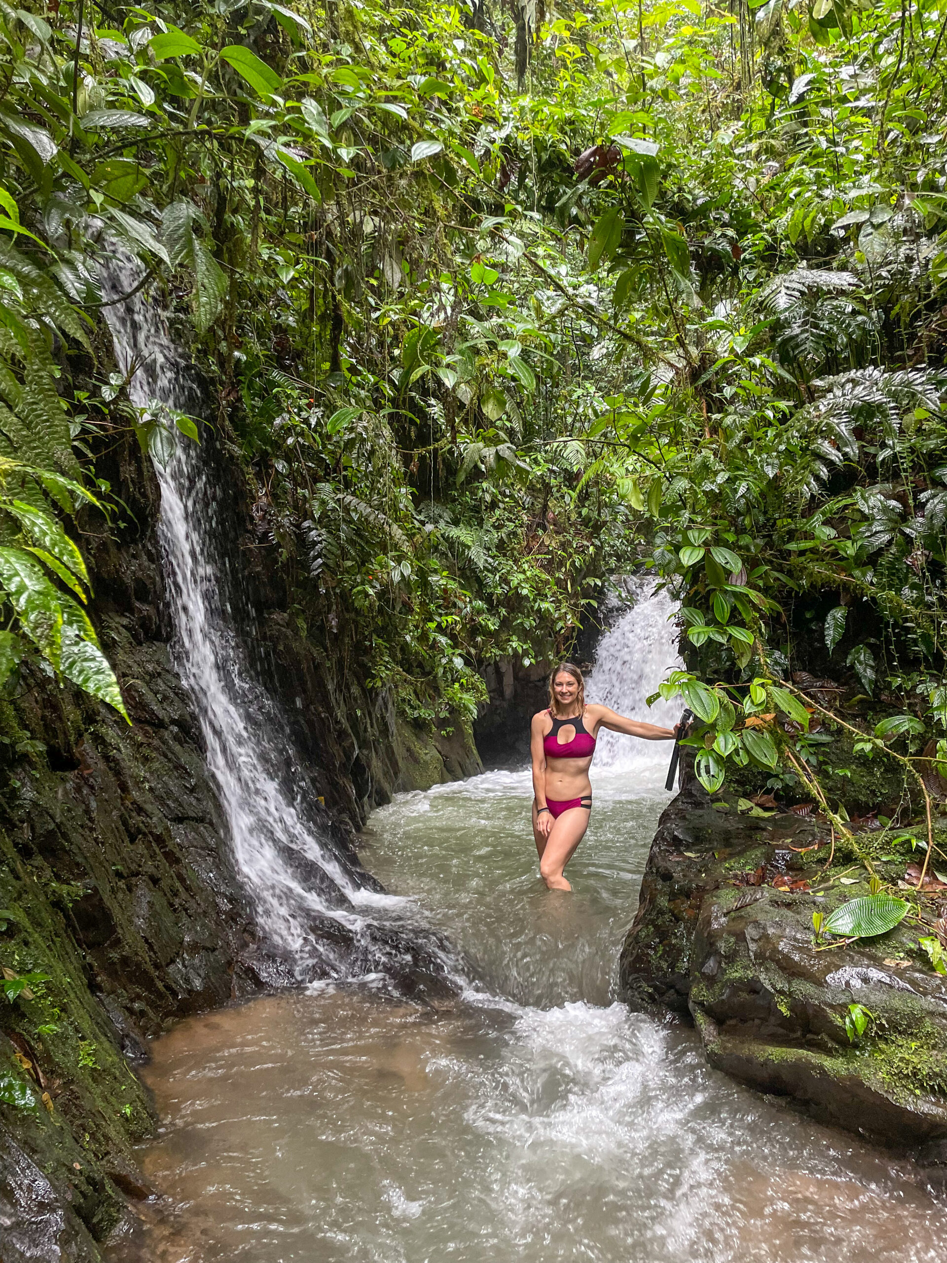 Women in waterfall in ecuador