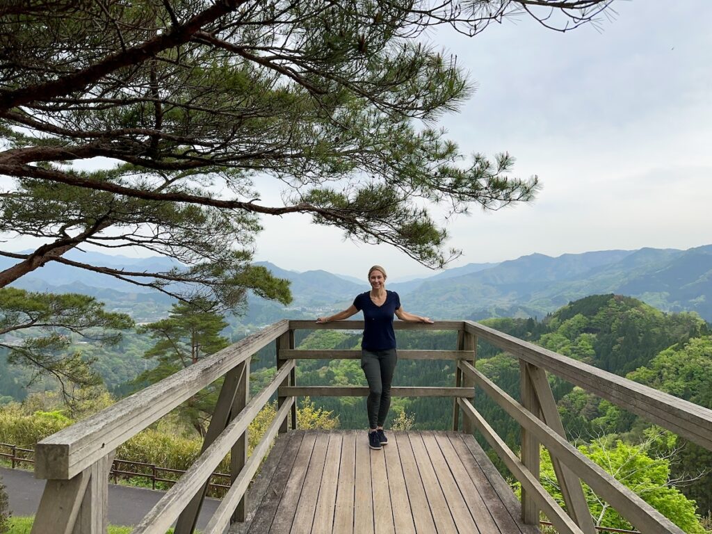 Alice Ford standing on an overlook in Kyushu, Japan during a solo traveling trip to places off the beaten path on the archipelago