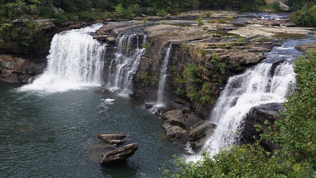 Aerial view of waterfalls flowing over rock in Little River Canyon near Fort Payne, Alabama on a summer day to show the best backcountry swimming holes to explore