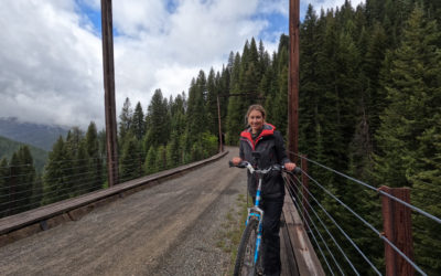 women with bicycle on the train trestles of the hiawatha route