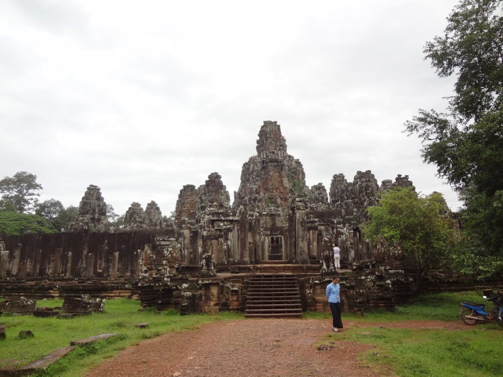 women walking in front of Bayon temple during Alice Ford's trip exploring Angkor Wat