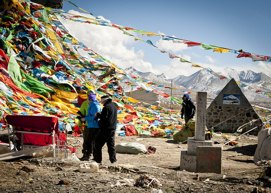 Prayer flags hang over a mountain in tibet 