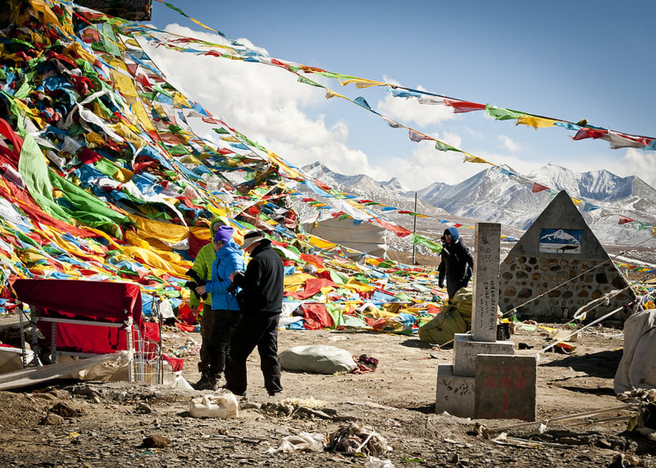 Prayer flags hang over a mountain in tibet