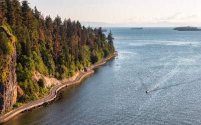 Aerial View from Lions Gate Bridge of Famous Seawall in Stanley Park. Sunny Summer Sunset. Downtown Vancouver, British Columbia, Canada.