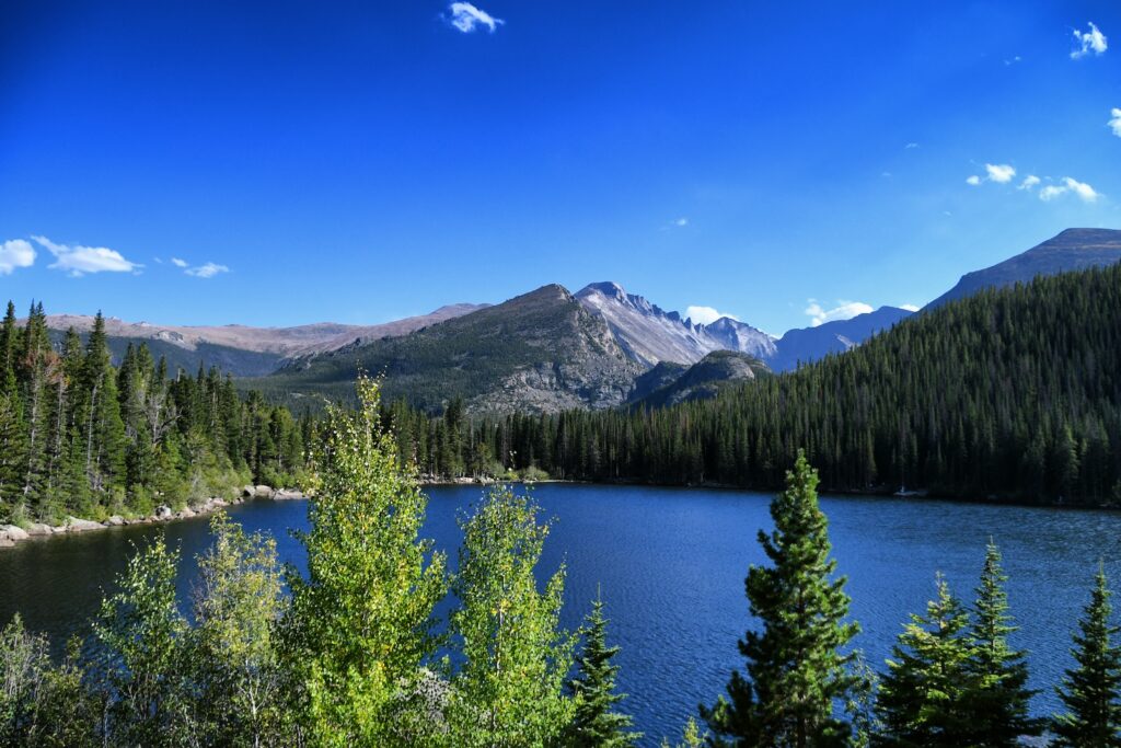 Pictured is Bear Lake in Estes Park, CO, one of the top places to explore during a 14-day coast to coast national parks road trip with a stop in Rocky Mountain National Park