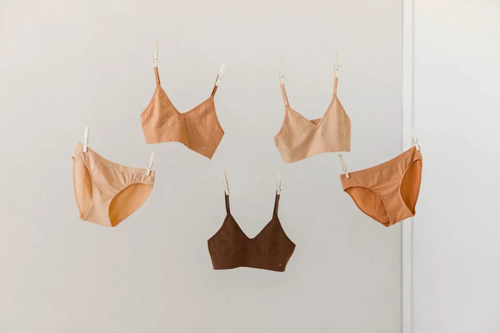 Branwyn Merino wool bralettes and seamless underwear shown hanging from clothespins for an outdoor holiday gift list for 2024