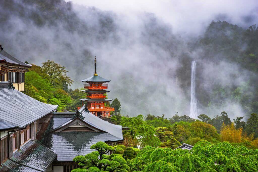 View of Nachi Taisha Shrine with fog settled around it in Nachi, Wakayama on the Kumano Kodo Pilgrimage Trail for a list of the best destinations for adventure in Japan