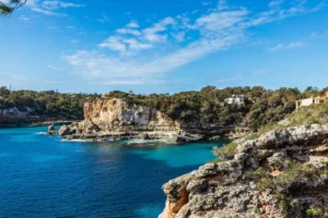 A natural rock arch above turquoise Mediterranean water