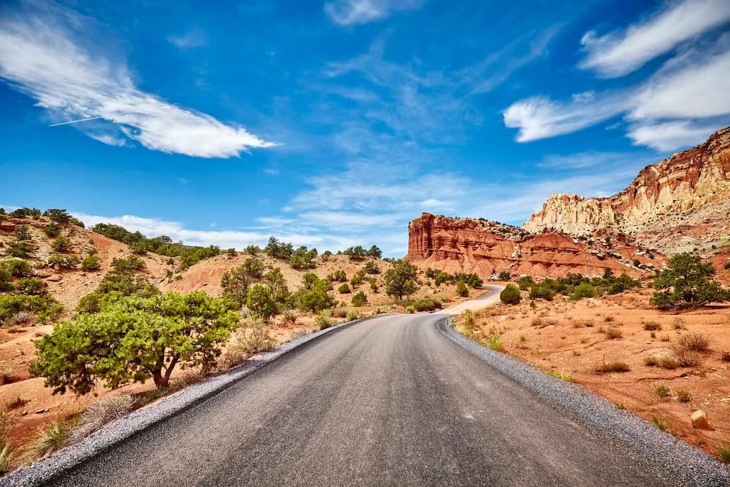 A scenic road running between red sandstone cliffs in Capitol Reef National Park