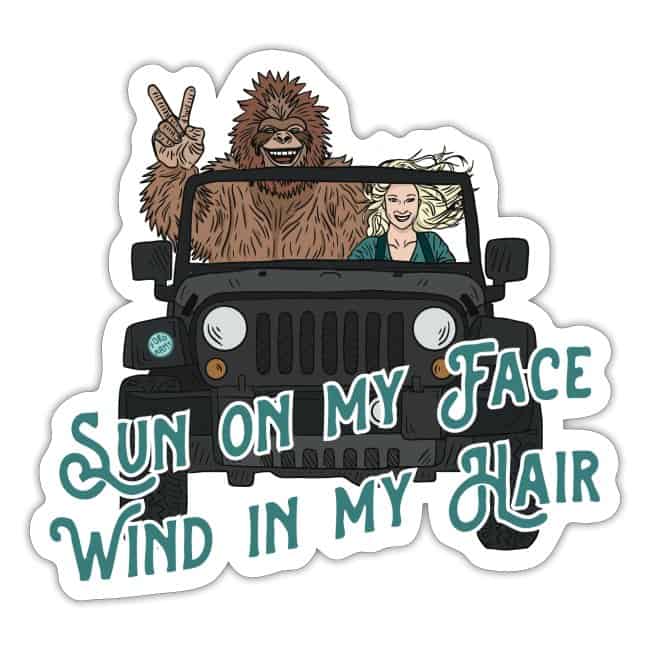 Pictured is a fun gift idea for outdoor lovers with Sasquatch shown in a Jeep with a blonde woman that reads Sun on my face, wind in my hair