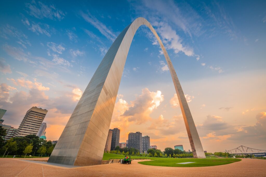 St. Louis Gateway Arch National Park seen at dusk downtown with the skyline behind it for a 14-day itinerary through national parks across the United States