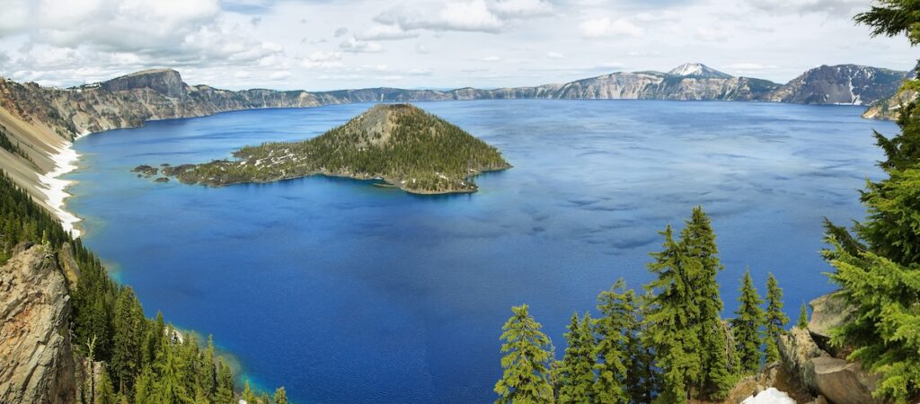 Aerial view of Wizard Island on Crater Lake, part of a 7-day road trip route through 4 Pacific Northwest national parks in Washington and Oregon